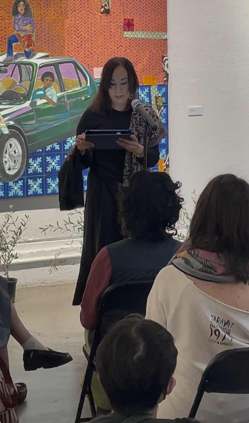 Sabina reading from her work at a live event